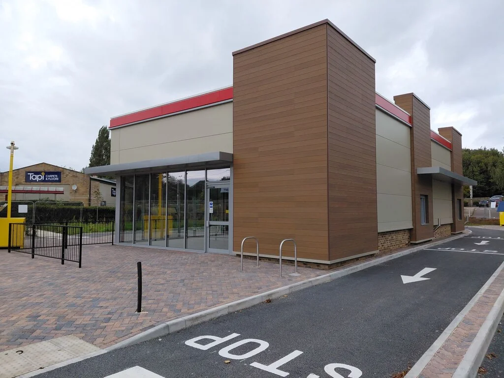 Newly completed roadside drive-through restaurant unit with drive-through lane, before signage